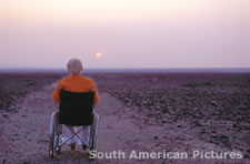 pgm0154 Maria Reiche 90 years old in a wheelchair / Nasca desert
